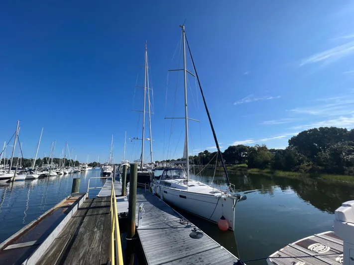 Serendipity Yacht Photos Pics 2013 Beneteau Oceanis 45 sailboat docked at a marina under clear blue skies.
