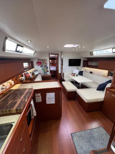 Serendipity Yacht Photos Pics Interior of 2013 Beneteau Oceanis 45 yacht with modern kitchen and cozy seating area.