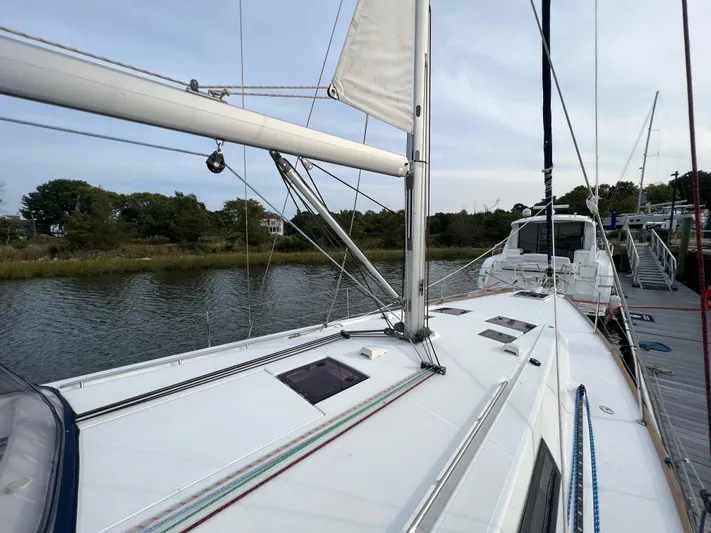 Serendipity Yacht Photos Pics 2013 Beneteau Oceanis 45 sailboat docked by a serene riverbank.