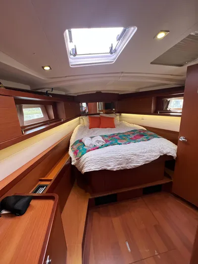 Serendipity Yacht Photos Pics Interior cabin of 2013 Beneteau Oceanis 45 yacht with cozy bed and wooden finish.