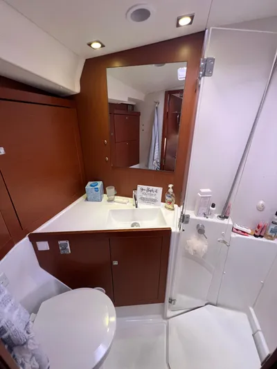 Serendipity Yacht Photos Pics Bathroom interior of 2013 Beneteau Oceanis 45 yacht, featuring sink, mirror, and toilet.