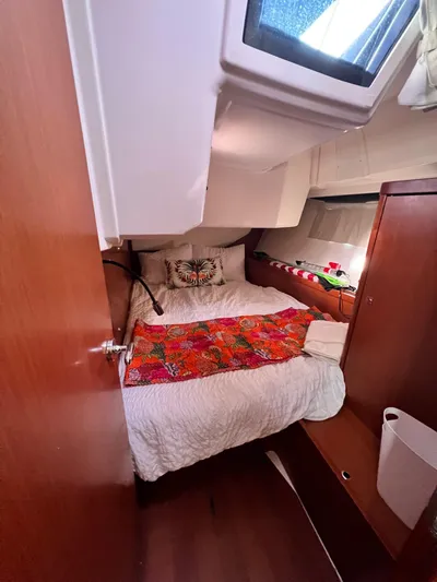 Serendipity Yacht Photos Pics Cozy cabin interior of 2013 Beneteau Oceanis 45 sailboat with colorful bedding.