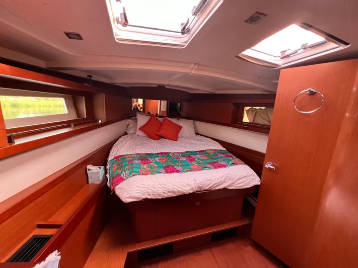 Serendipity Yacht Photos Pics Cozy cabin interior of 2013 Beneteau Oceanis 45 sailboat with skylights and colorful bedding.