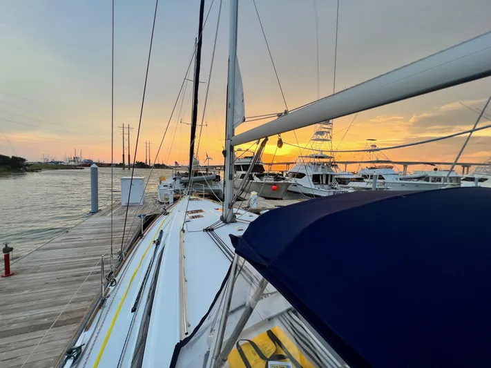 Serendipity Yacht Photos Pics 2013 Beneteau Oceanis 45 sailboat docked at sunset, with vibrant sky and calm waters.