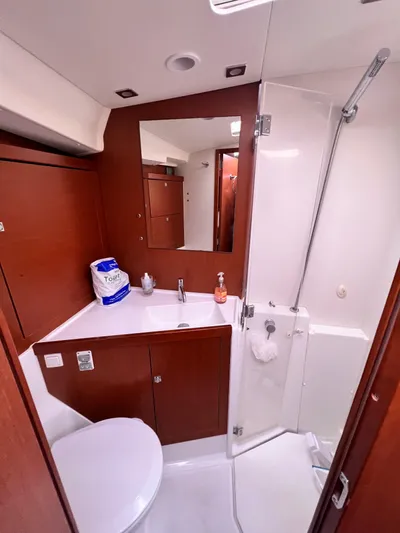 Serendipity Yacht Photos Pics Bathroom interior of 2013 Beneteau Oceanis 45 yacht, featuring modern fixtures and wood accents.