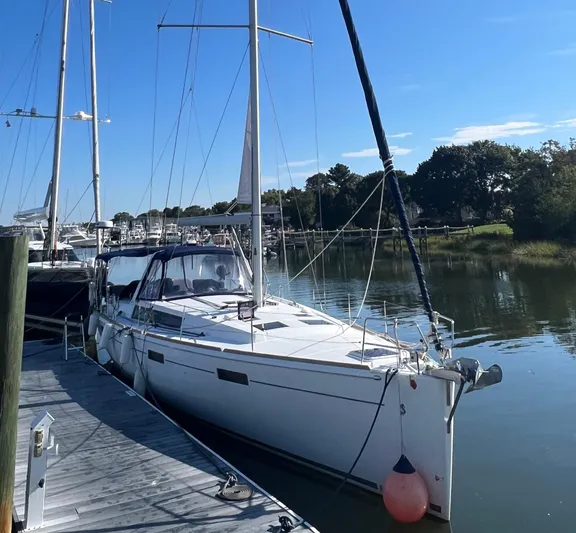 Serendipity Yacht Photos Pics 2013 Beneteau Oceanis 45 sailboat docked in a serene marina setting.