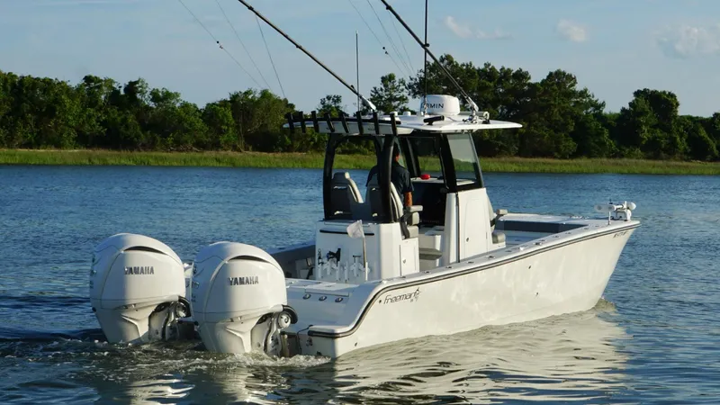  Yacht Photos Pics 2024 Freeman 28 boat with dual Yamaha engines on a calm lake.
