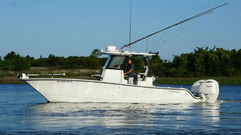  Yacht Photos Pics 2024 Freeman 28 boat on water with fishing rods and Yamaha engines.