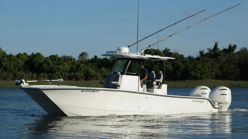  Yacht Photos Pics 2024 Freeman 28 boat on water with dual Yamaha engines, trees in background.