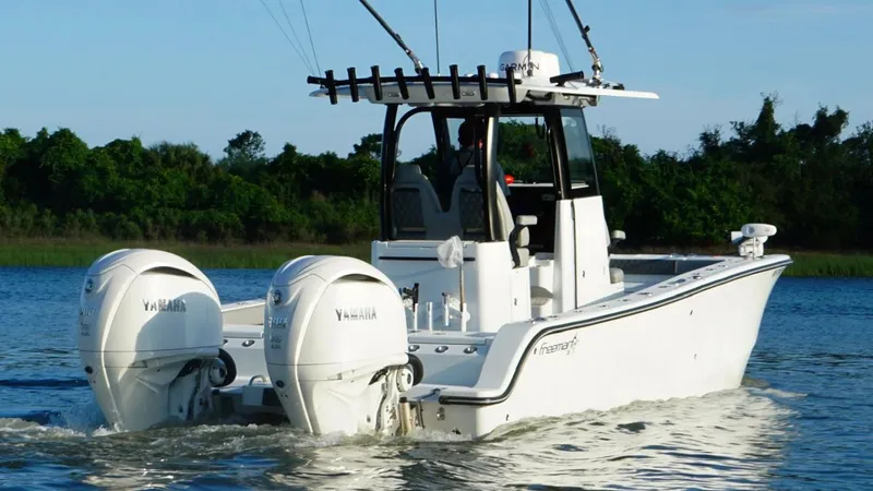  Yacht Photos Pics 2024 Freeman 28 boat with dual Yamaha engines on a calm lake.