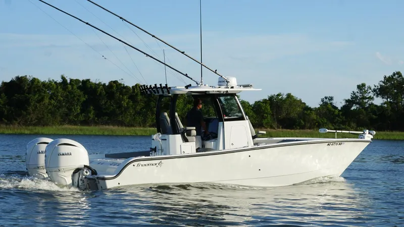  Yacht Photos Pics 2024 Freeman 28 boat cruising on a calm lake with dual Yamaha engines.