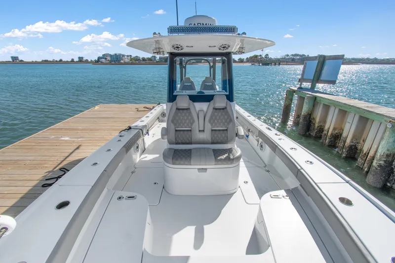  Yacht Photos Pics 2024 Freeman 28 boat docked by the water, showcasing sleek design and spacious seating.