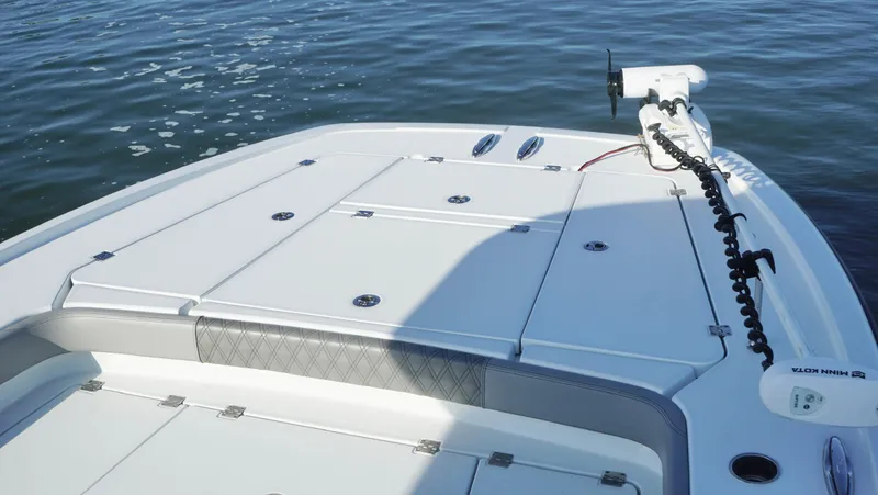  Yacht Photos Pics 2024 Freeman 28 boat deck with trolling motor on calm water.