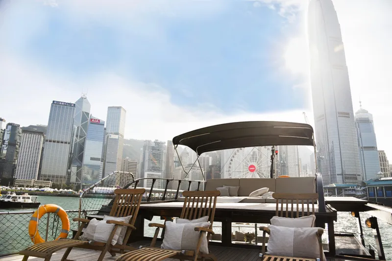 Gaiole Yacht Photos Pics Luxurious 1994 Custom Junk boat with city skyline and skyscrapers in the background.