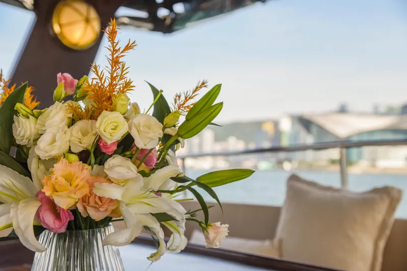 Gaiole Yacht Photos Pics Floral arrangement on a 1994 Custom Junk boat with cityscape background.