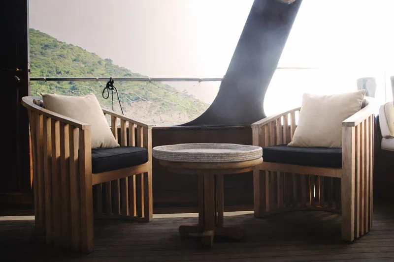 Gaiole Yacht Photos Pics Cozy seating area on a 1994 Custom Junk boat with scenic mountain view.