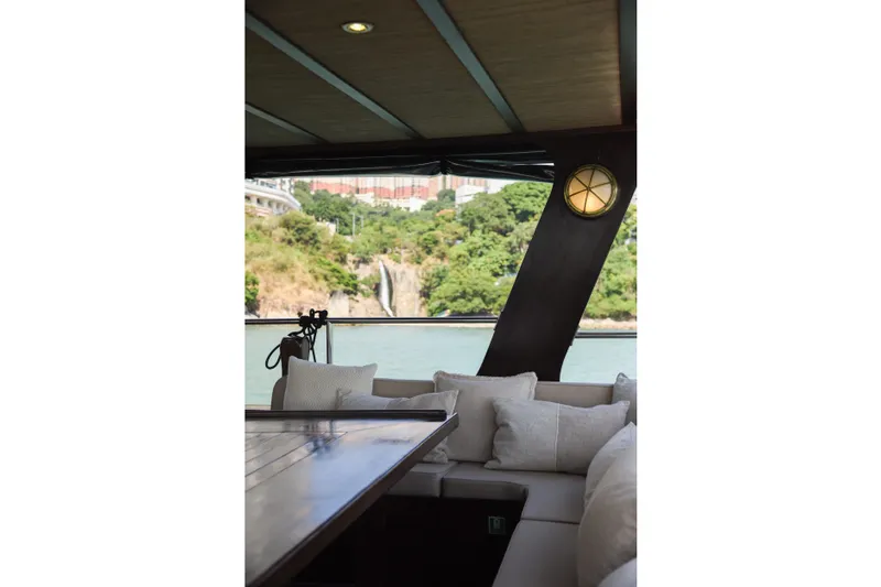 Gaiole Yacht Photos Pics Luxurious yacht interior with cushions, overlooking scenic waterfall and greenery. Custom Junk, 1994 model.