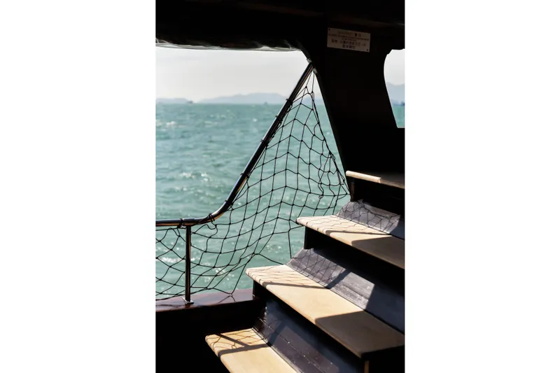 Gaiole Yacht Photos Pics Staircase on a 1994 Custom Junk boat overlooking the ocean.