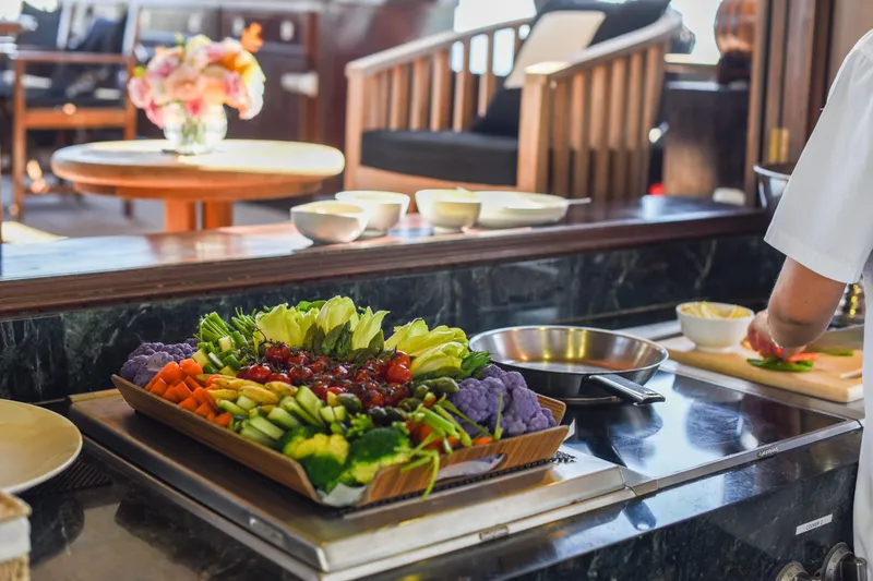 Gaiole Yacht Photos Pics Luxurious dining setup with fresh vegetables on a 1994 Custom Junk yacht.