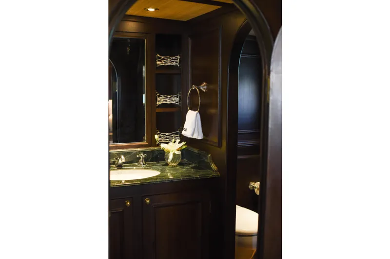 Gaiole Yacht Photos Pics Luxurious yacht bathroom with dark wood cabinetry and elegant marble countertop, Custom Junk 1994 model.