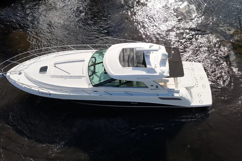 Yacht Photos Pics 2011 Sea Ray 450 Sundancer yacht cruising on water, aerial view.