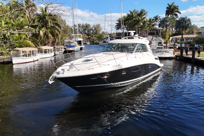  Yacht Photos Pics 2011 Sea Ray 450 Sundancer yacht cruising in a scenic, tropical marina.
