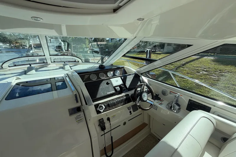  Yacht Photos Pics Interior helm of 2011 Sea Ray 450 Sundancer yacht, featuring modern controls and steering wheel.
