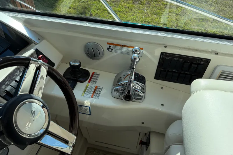  Yacht Photos Pics 2011 Sea Ray 450 Sundancer helm with steering wheel and control panel.