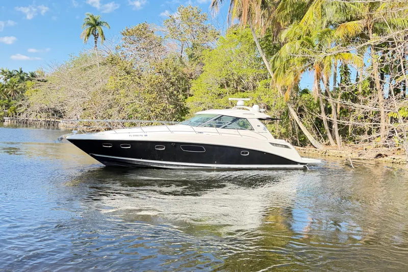  Yacht Photos Pics 2011 Sea Ray 450 Sundancer yacht cruising on a scenic, tropical waterway.