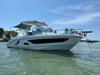  Yacht Photos Pics 2023 Beneteau Flyer 9 SUNdeck boat on calm water under clear sky.