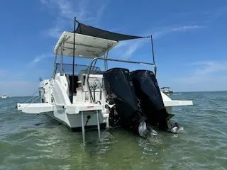  Yacht Photos Pics 2023 Beneteau Flyer 9 SUNdeck boat with dual outboard motors on the water.