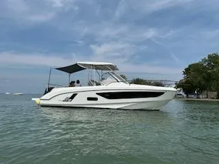  Yacht Photos Pics 2023 Beneteau Flyer 9 SUNdeck boat on calm water under a blue sky.