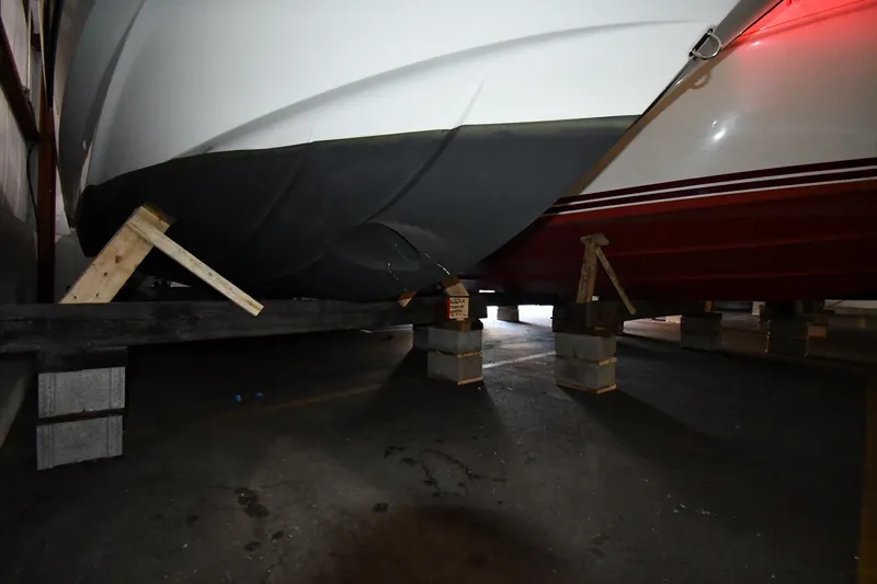  Yacht Photos Pics 2023 Beneteau Flyer 9 SUNdeck boat hull supported on blocks in storage.