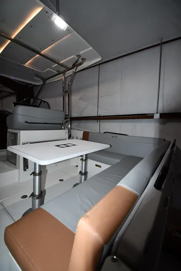  Yacht Photos Pics 2023 Beneteau Flyer 9 SUNdeck interior with seating and table.