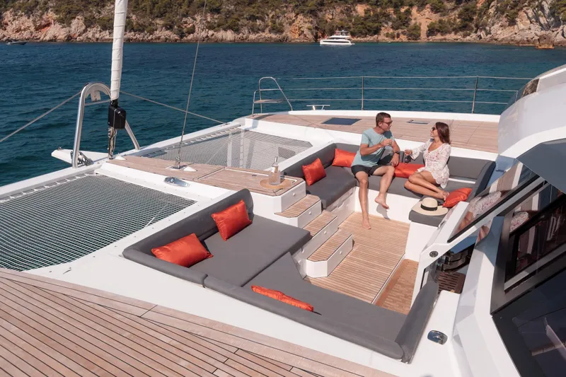  Yacht Photos Pics Couple relaxing on 2025 Fountaine Pajot Samana 59 yacht, enjoying ocean view.