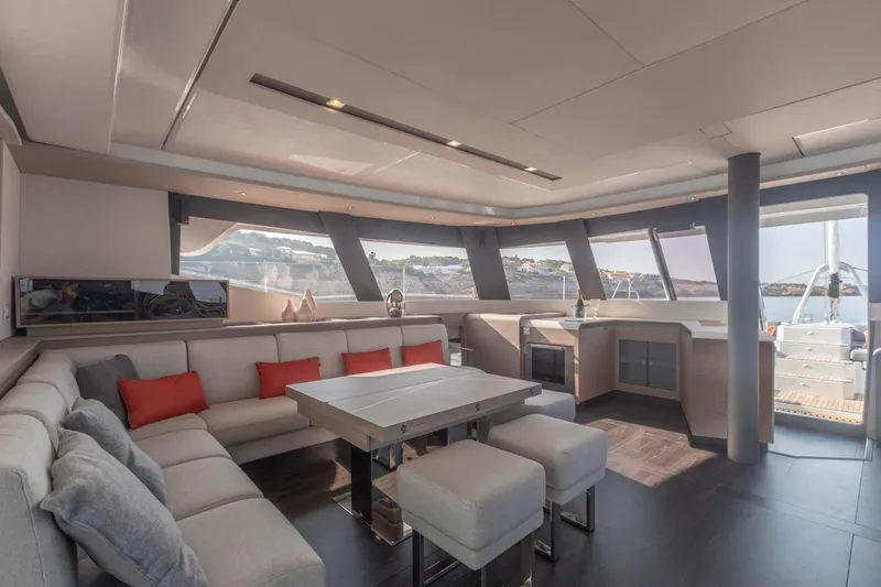  Yacht Photos Pics Luxurious interior of 2025 Fountaine Pajot Samana 59 yacht with modern seating and panoramic windows.