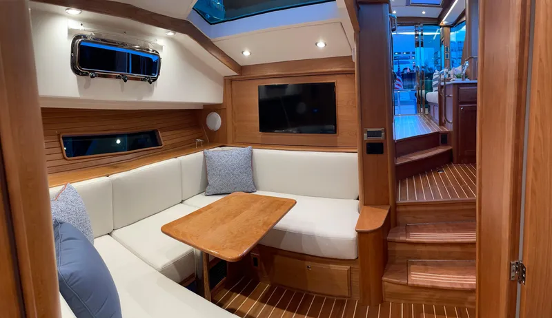  Yacht Photos Pics 2023 Sabre 43 Salon Express interior with cozy seating and wooden accents.