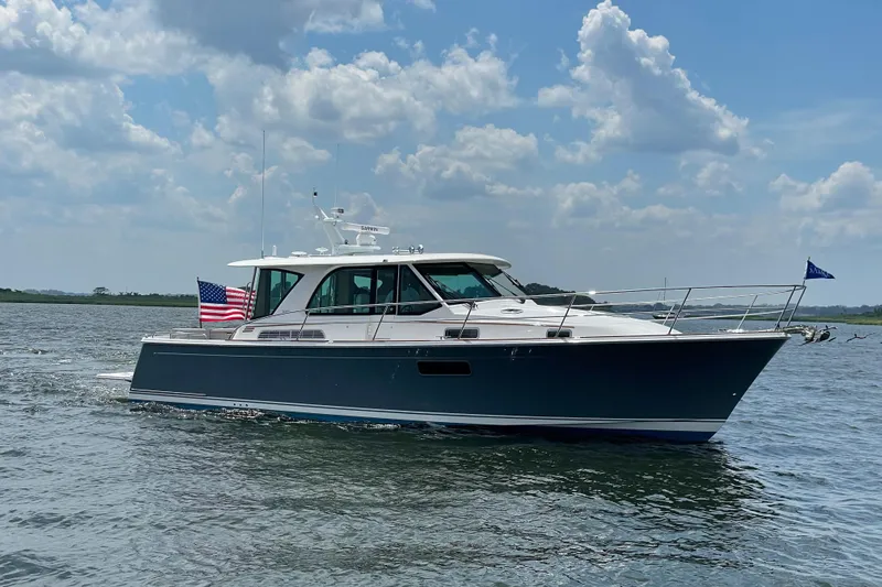  Yacht Photos Pics 2023 Sabre 43 Salon Express yacht cruising on a sunny day with American flag.