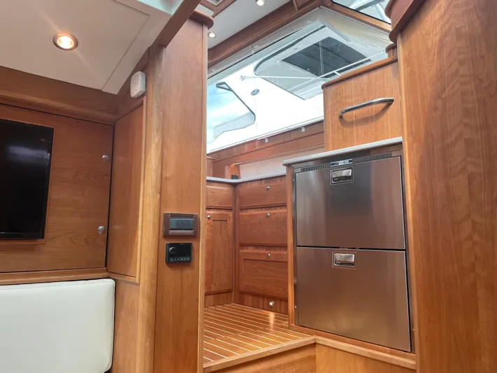  Yacht Photos Pics 2023 Sabre 43 Salon Express interior with wood finish and stainless steel appliances.