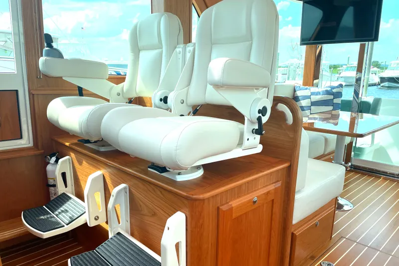  Yacht Photos Pics Luxury interior of 2023 Sabre 43 Salon Express with plush white seating and wooden accents.