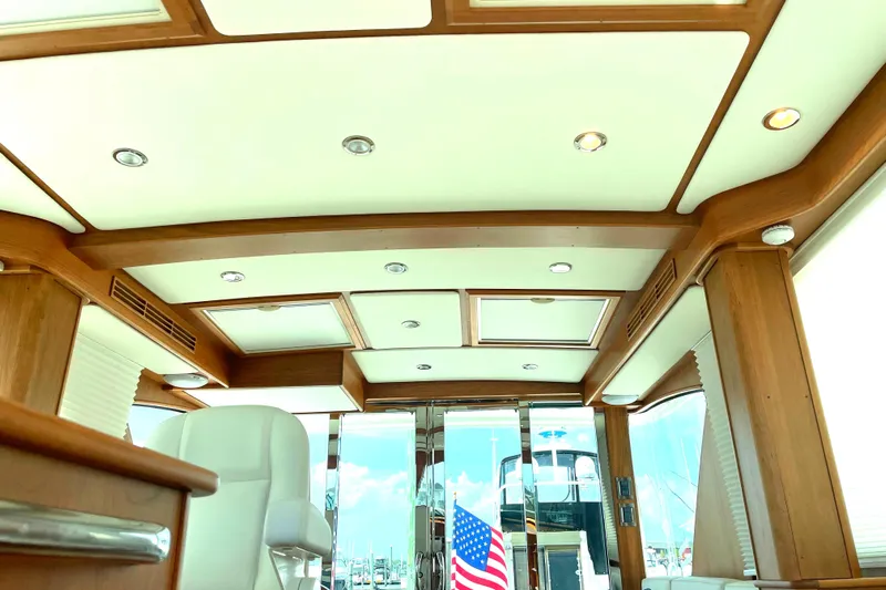  Yacht Photos Pics Interior of 2023 Sabre 43 Salon Express yacht with elegant wood finish and American flag.