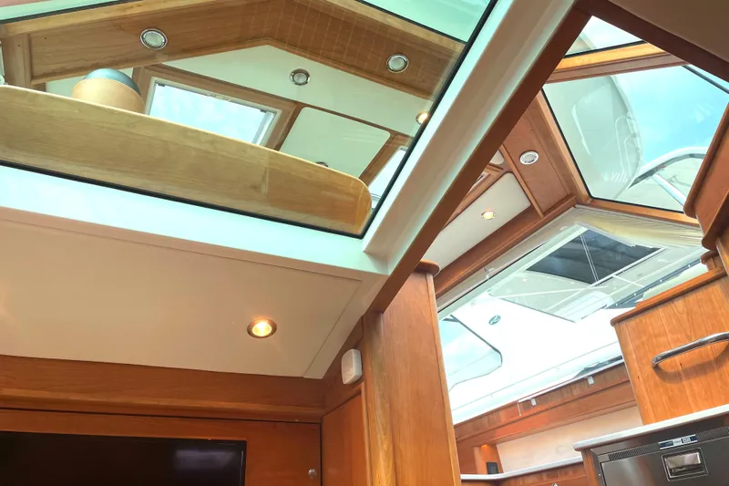  Yacht Photos Pics Interior view of 2023 Sabre 43 Salon Express yacht with skylights and wooden finishes.
