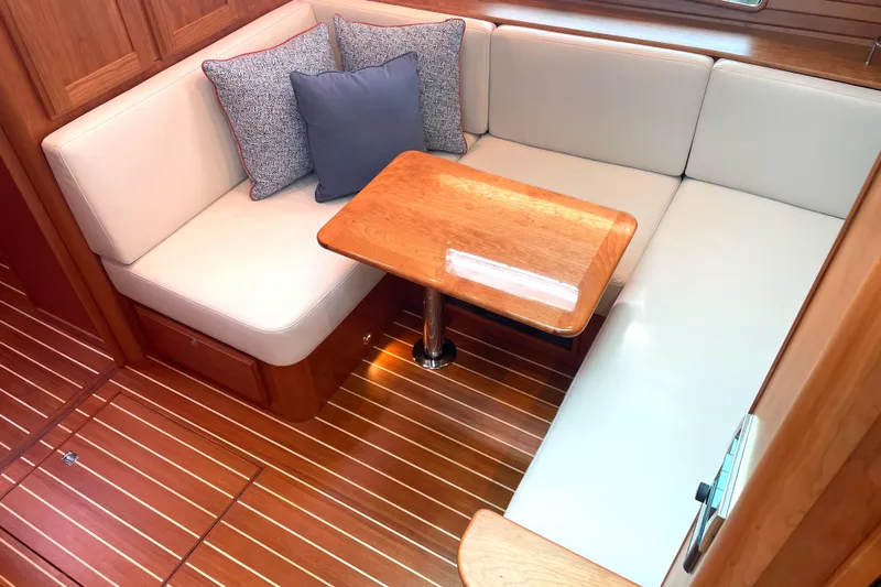  Yacht Photos Pics 2023 Sabre 43 Salon Express interior with cozy seating and wooden table.