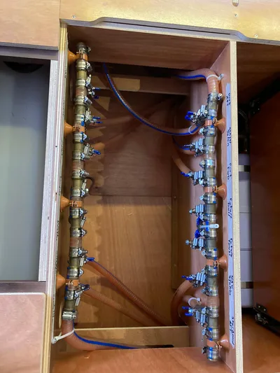 Vela Yacht Photos Pics Electrical panel inside a 2018 Lagoon 42 catamaran, showcasing wiring and connectors.