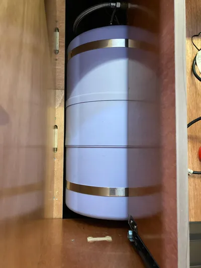 Vela Yacht Photos Pics Water heater tank inside a 2018 Lagoon 42 yacht's wooden compartment.