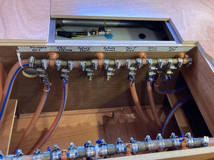 Vela Yacht Photos Pics Plumbing system of a 2018 Lagoon 42 yacht, showcasing labeled pipes and valves.