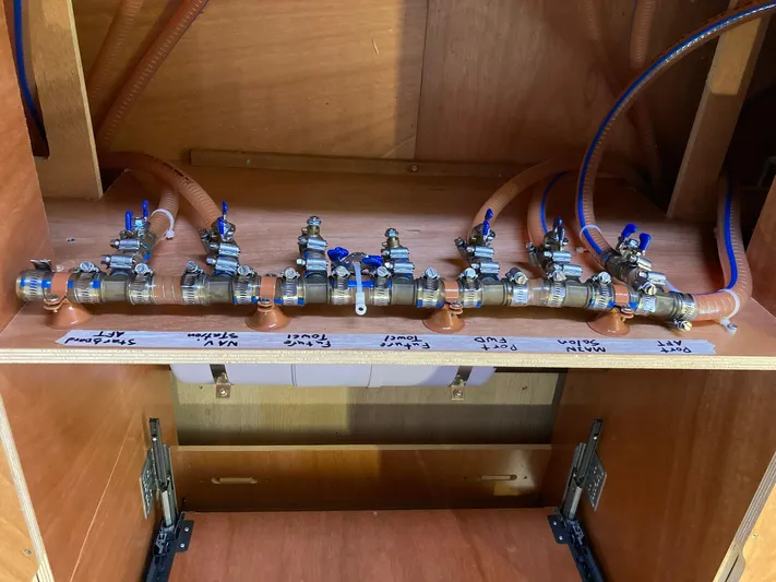 Vela Yacht Photos Pics Plumbing system of a 2018 Lagoon 42 yacht with labeled valves and pipes.