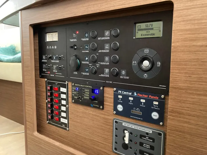 Vela Yacht Photos Pics Control panel of a 2018 Lagoon 42 yacht, featuring various switches and displays.