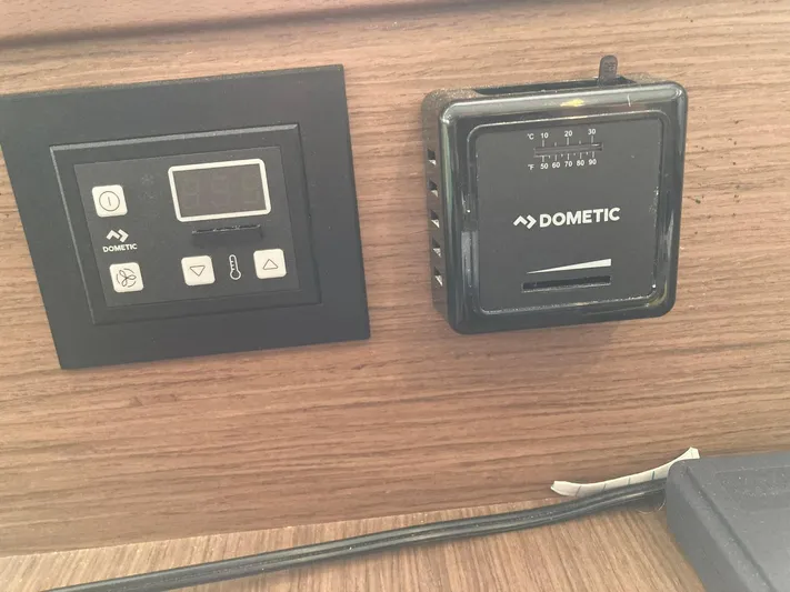 Vela Yacht Photos Pics Dometic control panels on 2018 Lagoon 42 yacht interior, mounted on wooden surface.