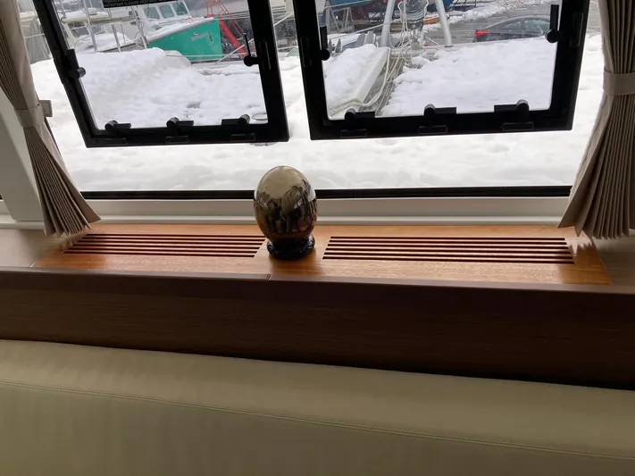 Vela Yacht Photos Pics Interior of 2018 Lagoon 42 yacht with decorative egg on wooden shelf.